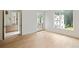 Bright, airy bedroom featuring hardwood floors, a view of the house, and an ensuite bathroom at 11560 Serenbe Ln, Chattahoochee Hills, GA 30268