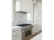 A well equipped kitchen, complete with stainless appliances and marble backsplash at 11560 Serenbe Ln, Chattahoochee Hills, GA 30268
