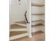 Modern staircase with wood steps and floating shelves at 11560 Serenbe Ln, Chattahoochee Hills, GA 30268