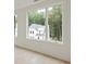 Scenic view from the window showcasing a picturesque landscape with lush trees and a glimpse of a home at 11560 Serenbe Ln, Chattahoochee Hills, GA 30268