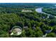 Aerial view of a beautiful home surrounded by lush greenery and water features at 3245 Bywater Trl, Roswell, GA 30075