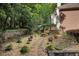 Well-maintained backyard features a water fountain, mature trees and lush landscaping at 3245 Bywater Trl, Roswell, GA 30075