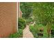 Beautiful backyard featuring a brick walkway through landscaped garden at 3245 Bywater Trl, Roswell, GA 30075