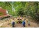 Beautiful landscaped backyard featuring a charming water fountain and flowering plants at 3245 Bywater Trl, Roswell, GA 30075