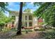Lush backyard featuring a stone patio, hammock, and verdant surroundings for outdoor enjoyment at 3245 Bywater Trl, Roswell, GA 30075