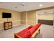 Basement features carpeted floors, a TV, and comfortable seating, perfect for relaxation and entertainment at 3245 Bywater Trl, Roswell, GA 30075