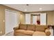 Finished basement with a large sofa, and doorway leading to another room at 3245 Bywater Trl, Roswell, GA 30075