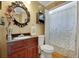 Charming bathroom with decorative mirror and a shower with a floral curtain at 3245 Bywater Trl, Roswell, GA 30075
