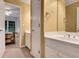 Bathroom featuring a double vanity, large mirror and an entrance into the bedroom at 3245 Bywater Trl, Roswell, GA 30075