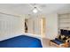 Bedroom featuring a built-in bookcase, ceiling fan, and an entrance to the bathroom at 3245 Bywater Trl, Roswell, GA 30075
