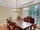 Formal dining room features a large window, chandelier, and traditional furnishings at 3245 Bywater Trl, Roswell, GA 30075