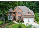 Beautiful brick two-story home featuring an attached two-car garage and green lawn at 3245 Bywater Trl, Roswell, GA 30075
