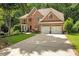 Attractive two-story brick home with two-car garage and long concrete driveway at 3245 Bywater Trl, Roswell, GA 30075