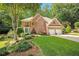 Traditional two-story brick home with a well-manicured lawn and two-car garage at 3245 Bywater Trl, Roswell, GA 30075