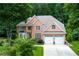 Stunning brick two-story home with a two-car garage and mature trees at 3245 Bywater Trl, Roswell, GA 30075