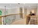 Upper hallway with wrought iron railing and views to the bedrooms below at 3245 Bywater Trl, Roswell, GA 30075