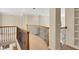 Upper hallway with carpet, decorative wrought iron railing and white built-in shelving at 3245 Bywater Trl, Roswell, GA 30075