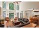 Bright living room boasts large windows, a ceiling fan, and hardwood floors at 3245 Bywater Trl, Roswell, GA 30075