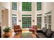 Sun-drenched living room with hardwood floors and many windows at 3245 Bywater Trl, Roswell, GA 30075