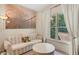 Sitting area with large window and daybed, plus tree-themed print on the wall at 3245 Bywater Trl, Roswell, GA 30075