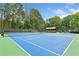 Community tennis courts with lush greenery and covered pavilion nearby at 3245 Bywater Trl, Roswell, GA 30075