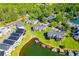 An aerial view of lakeside homes with boat docks surrounded by lush greenery and serene lake waters at 325 Berry Ct, Villa Rica, GA 30180
