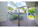 Charming, cozy covered balcony with wooden floors offering privacy from the surrounding greenery at 325 Berry Ct, Villa Rica, GA 30180