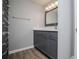Bathroom featuring gray vanity with countertop sink, gray walls, and decorative mirror with lighting at 325 Berry Ct, Villa Rica, GA 30180