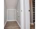 Bathroom featuring washer and dryer hookups, gray walls, white trim, and wood-look flooring at 325 Berry Ct, Villa Rica, GA 30180