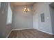 A dining area with gray walls, wood floors, and an ornate chandelier at 325 Berry Ct, Villa Rica, GA 30180