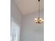 A dining area with gray walls, wood floors, and an ornate chandelier at 325 Berry Ct, Villa Rica, GA 30180
