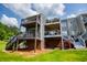 Exterior view showcasing tiered decks, lawn, and community living at 325 Berry Ct, Villa Rica, GA 30180