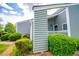 Stylish condo exterior exhibits manicured shrubbery, green siding, and welcoming entry at 325 Berry Ct, Villa Rica, GA 30180
