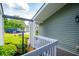 Cozy covered porch featuring grey railings, green siding, and ample natural light at 325 Berry Ct, Villa Rica, GA 30180