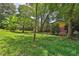 A spacious backyard with lush greenery, mature trees, and wood deck at 4246 Rue Saint Michel, Stone Mountain, GA 30083