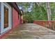 A backyard deck featuring wood planks with railing and door leading into home at 4246 Rue Saint Michel, Stone Mountain, GA 30083