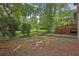 A backyard patio with brick and stairs surrounded by beautiful greenery and a brick walkway at 4246 Rue Saint Michel, Stone Mountain, GA 30083