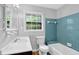 Bathroom with a vanity, wood floors, and blue tiled walls, featuring natural light from a window at 4246 Rue Saint Michel, Stone Mountain, GA 30083
