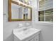 Bright bathroom with a large mirror, hardwood floors, and natural light from a window at 4246 Rue Saint Michel, Stone Mountain, GA 30083