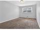 Bedroom with neutral walls, carpet flooring, and a window with natural light at 4246 Rue Saint Michel, Stone Mountain, GA 30083