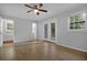 Bright bedroom with hardwood floors and a ceiling fan, featuring double doors leading to the outside at 4246 Rue Saint Michel, Stone Mountain, GA 30083
