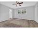 Spacious bedroom featuring neutral walls, carpet, ceiling fan and natural light from a large window at 4246 Rue Saint Michel, Stone Mountain, GA 30083