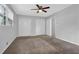 Cozy bedroom featuring neutral walls, carpet, ceiling fan, closet space and natural light from a window at 4246 Rue Saint Michel, Stone Mountain, GA 30083