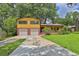 Charming two-story home with brick and siding, featuring an attached two-car garage and a well-maintained front yard at 4246 Rue Saint Michel, Stone Mountain, GA 30083