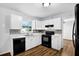 A spacious kitchen with white cabinets, black appliances, and lots of counter space at 4246 Rue Saint Michel, Stone Mountain, GA 30083