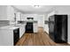 A spacious kitchen with white cabinets, black appliances, and lots of counter space at 4246 Rue Saint Michel, Stone Mountain, GA 30083
