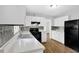 A spacious kitchen with white cabinets, black appliances, and lots of counter space at 4246 Rue Saint Michel, Stone Mountain, GA 30083