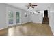 Living room boasting hardwood floors, a ceiling fan, and stairs leading to the kitchen at 4246 Rue Saint Michel, Stone Mountain, GA 30083