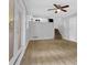 Living room boasting hardwood floors, a ceiling fan, and stairs leading to the kitchen at 4246 Rue Saint Michel, Stone Mountain, GA 30083