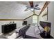 Staged attic bedroom showcasing wood beams, hard wood floors, and decor at 2685 Peachtree Walk Walk, Duluth, GA 30096